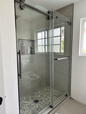 Custom Frameless sliding shower door with custom towel bar panel
SS04 Series