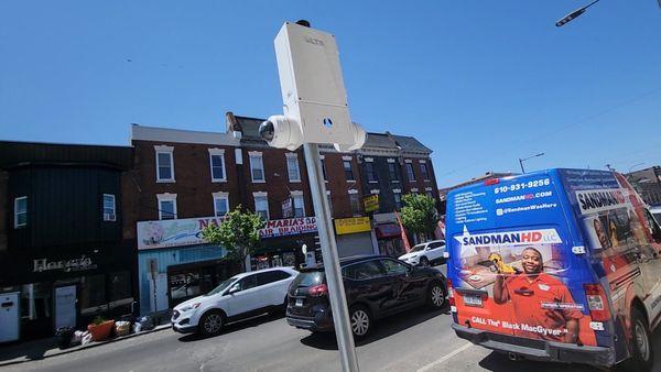 Photo of one of our trucks parked next to a Sentinel (a Pole erect from the sidewalk or ground with cameras mounted to it.