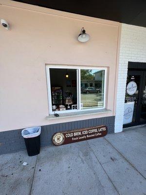 Just a window in a building with outdoor seating. Fun and new!