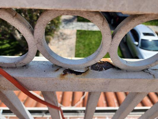 Close up rust on a metal railing.