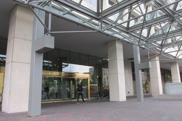 exterior view of doorway into large office building holding many DC offices