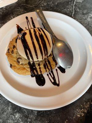 Cheap store bought chocolate chip cookie with freezer burned ice cream & fake chocolate sauce. Don't waste the calories.