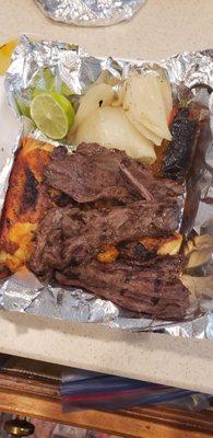 Mixed grill plate: 2 pieces of charbroilled chicken, half order steak, with grilled onions/peppers. Not pictured: rice , tortillas, beans