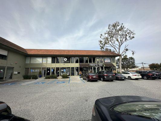 Tucked into the corner of the structure - keep an eye out for the driveway about 500 feet before 244th St