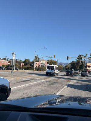 Taking a red light as kids cross the street