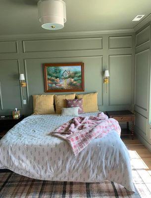 Green color drenched a master bedroom