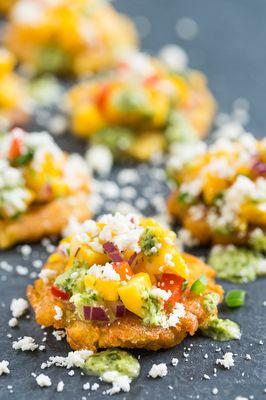"Tu no me tostone a mi!" Fried plantains with yellow a red peppers, red onions avocado and topped with shredded cheese!