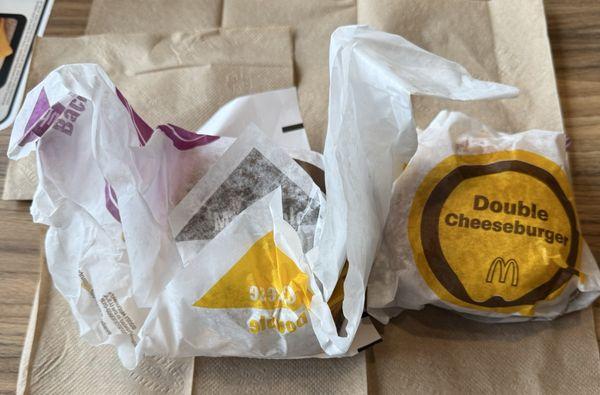 I'm pretty sure since one was without pickles they unwrapped it, picked them out then threw back in the bag