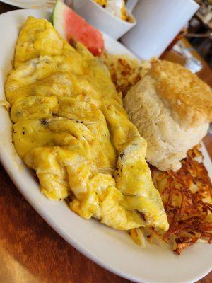 Meat lovers omelet with homemade biscuit.