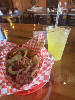 Fish taco and pineapple mineral water with Tajin
