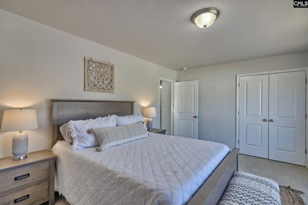 The primary suite features trey ceilings, a sitting room, private bath, separate vanities, a custom tile shower, garden tub, and more.