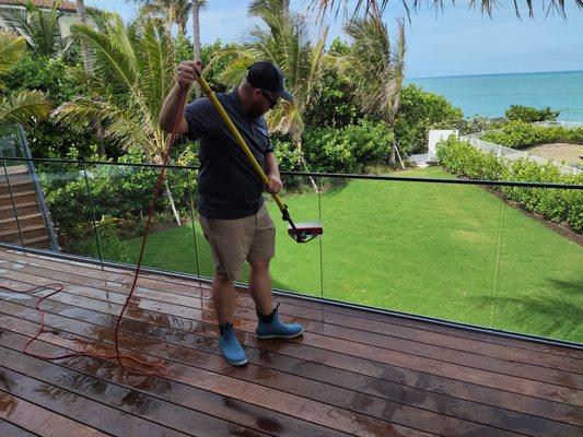 Cleaning glass railings overlooking the beautiful ocean in Indian River Shores, Florida.