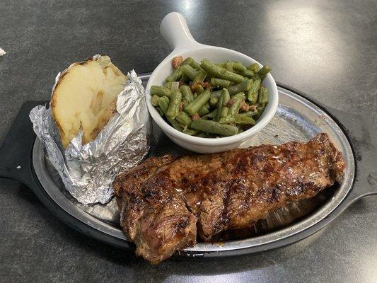 Strip steak, baked potato and green beans.
