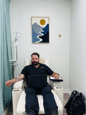 Comfort meets care. A client enjoying IV hydration in one of our relaxing lounge chairs -- because wellness should feel this good.