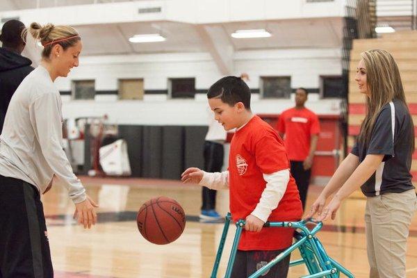 Athlete getting pointers from ESU player