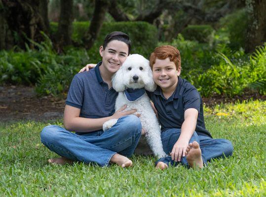 Two brothers with family dog.