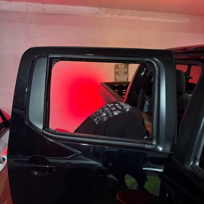 They're vacuuming the broken glass in this photo before putting the new glass in.