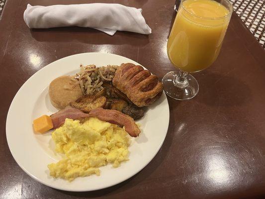 Breakfast Buffet: Scrambled eggs, bacon, biscuit, hash browns, strudel; Orange Juice