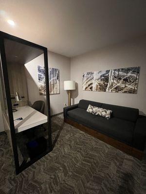 Desk and sofabed area. The glass windows by the desk slide, so you can have privacy at the desk if others are sleeping.