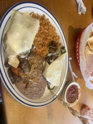 Steak Burrito topped with queso cheese,