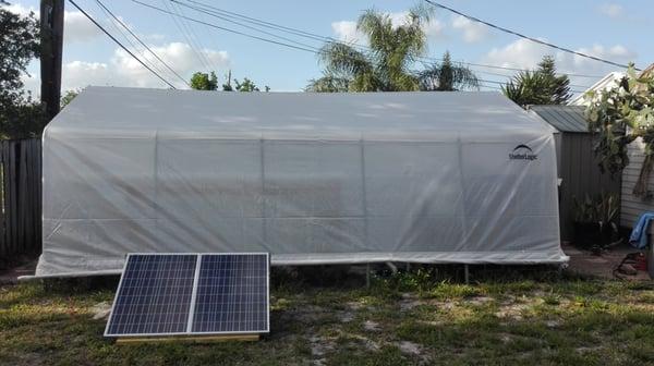 Greenhouse with solar ground mount