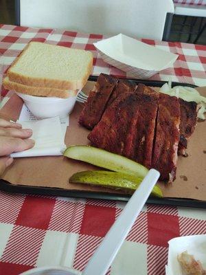Rack of ribs, bread, 1/2 pint potato salad and green beans off edge