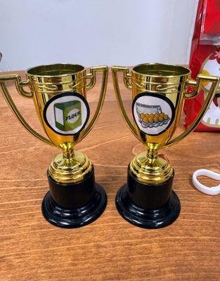 L Auntie's (Nadine C.) R mine Had no idea our trophies had different stickers on it.