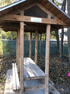 The enclosed picnic table built by an Eagle Scout