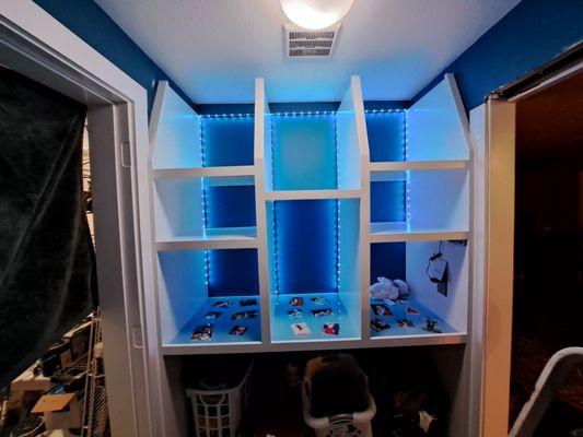 custom shelving, made from sanded plywood with no seams or nail holes. LED lights, and resin encased pictures of customers deceased mom