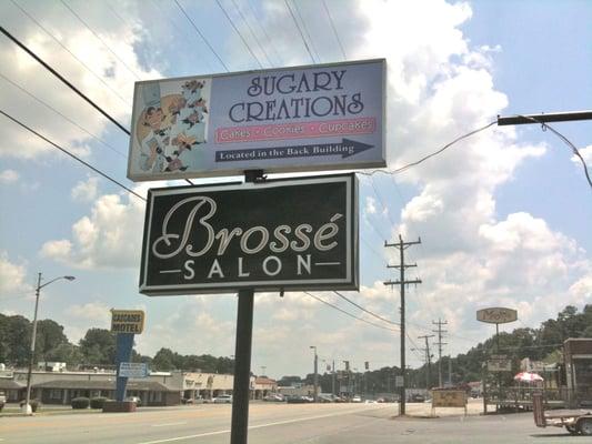 Look for our sign. Turn right before reaching the sign to find us. Spot the Pink & Purple doors & you're there!