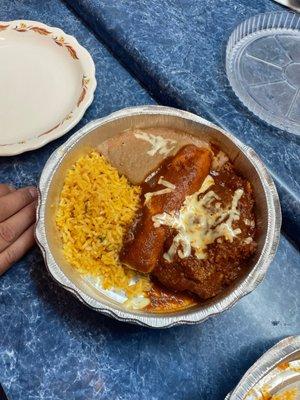 Enchilada, beef tamale, rice and beans.