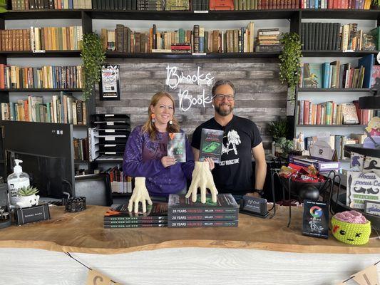 Bookstore front counter with friendly owner and local author