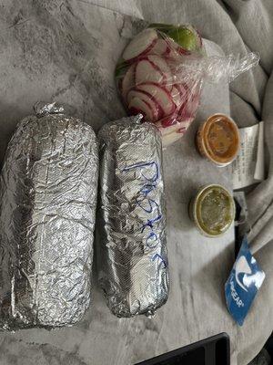 pastor and pollo burrito with salsa and radishes and limes