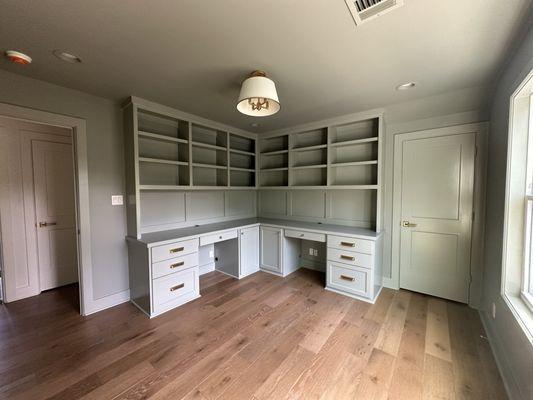 "Function meets finesse--built-in workspace with custom cabinetry and golden accents"