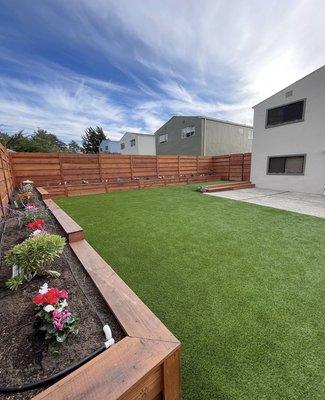After: Installed turf, redwood work and plants.