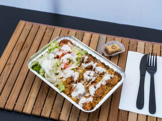 Mediterranean Grilled Chicken rice & salad over Goubaa grub sauce and Garlic aioli,