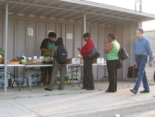 Evening commuters stopping by 200-Miles Produce, corner of 5th and Mandela Parkway.