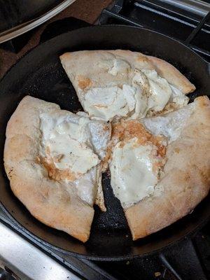 White personal pan pizza. We had to complete the baking at home because it was not done in the shop. The dough was sweet...