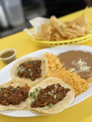 Pastor tacos, rice and beans, chips and chile verde