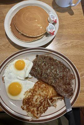 that's why steak and eggs with pancakes medium well New York steak Sunnyside of eggs