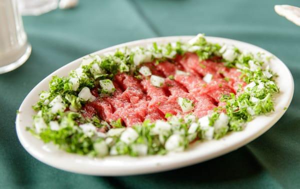 Kibbeh Neyye $10 "Raw beef, wheat, herbs and spices.": RAW GROUND BEEF.