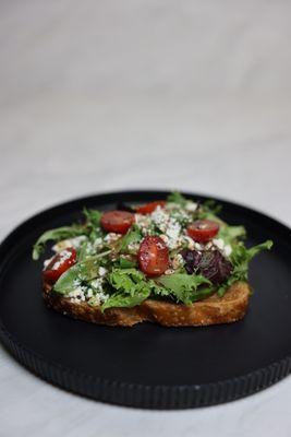Avocado Toast with spring mix freshly cut Grape tomatoes.