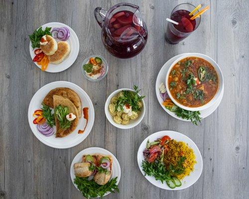 Assortment of Authentic Ukrainian food. Borcht soup, peiroguis, chicken chebureky or empanas, dumplings, the kompot drink and more.