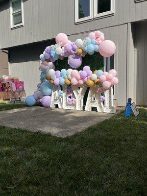 Balloon arches and boxwood backdrop (letters not included)