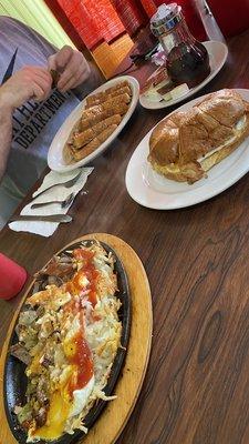 Skillet, bacon egg cheese croissant, French toast, OJ