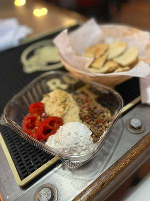 A really great meze plate with cream cheese tatziki, hummus, homemade pickled peppers and peta.