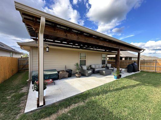 39x10' concrete slab with cedar pergola on risers with electrical ran for outlets and fans installed. (not gutters)