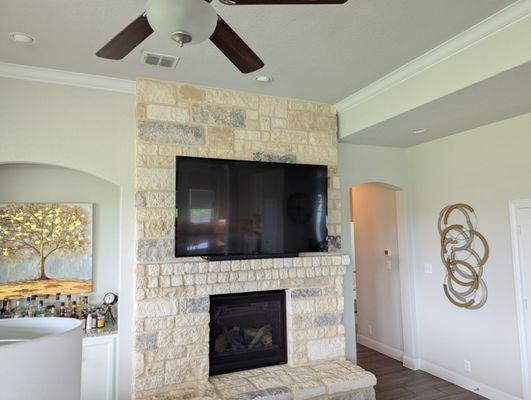 70" TV mount in stone above fireplace.