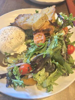 Burrata on a bed of delicious salad and focaccia