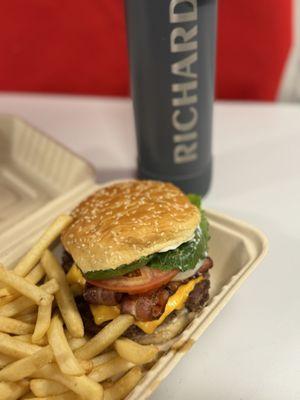 Bacon cheeseburger with bacon and fries.